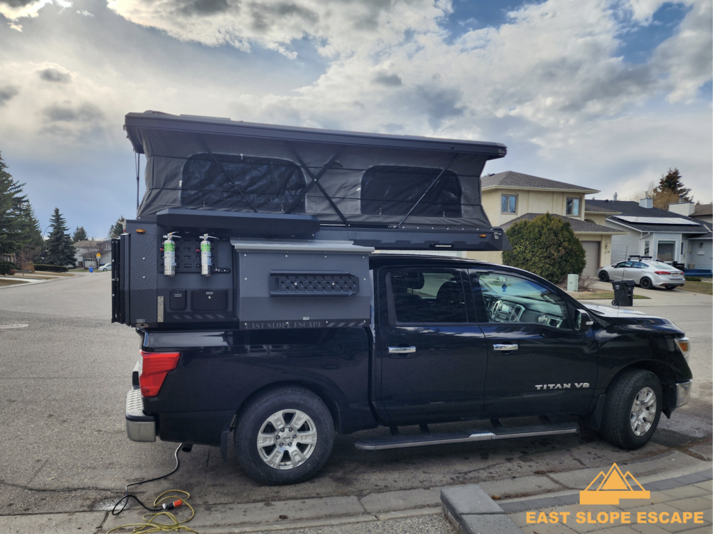 A truck bed camper in a suburban neighbourhood.